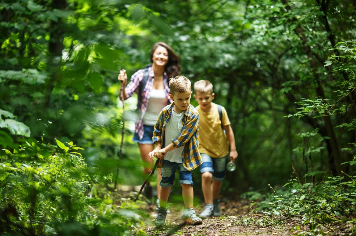 Family hiking on the trails at Graystones Preserve