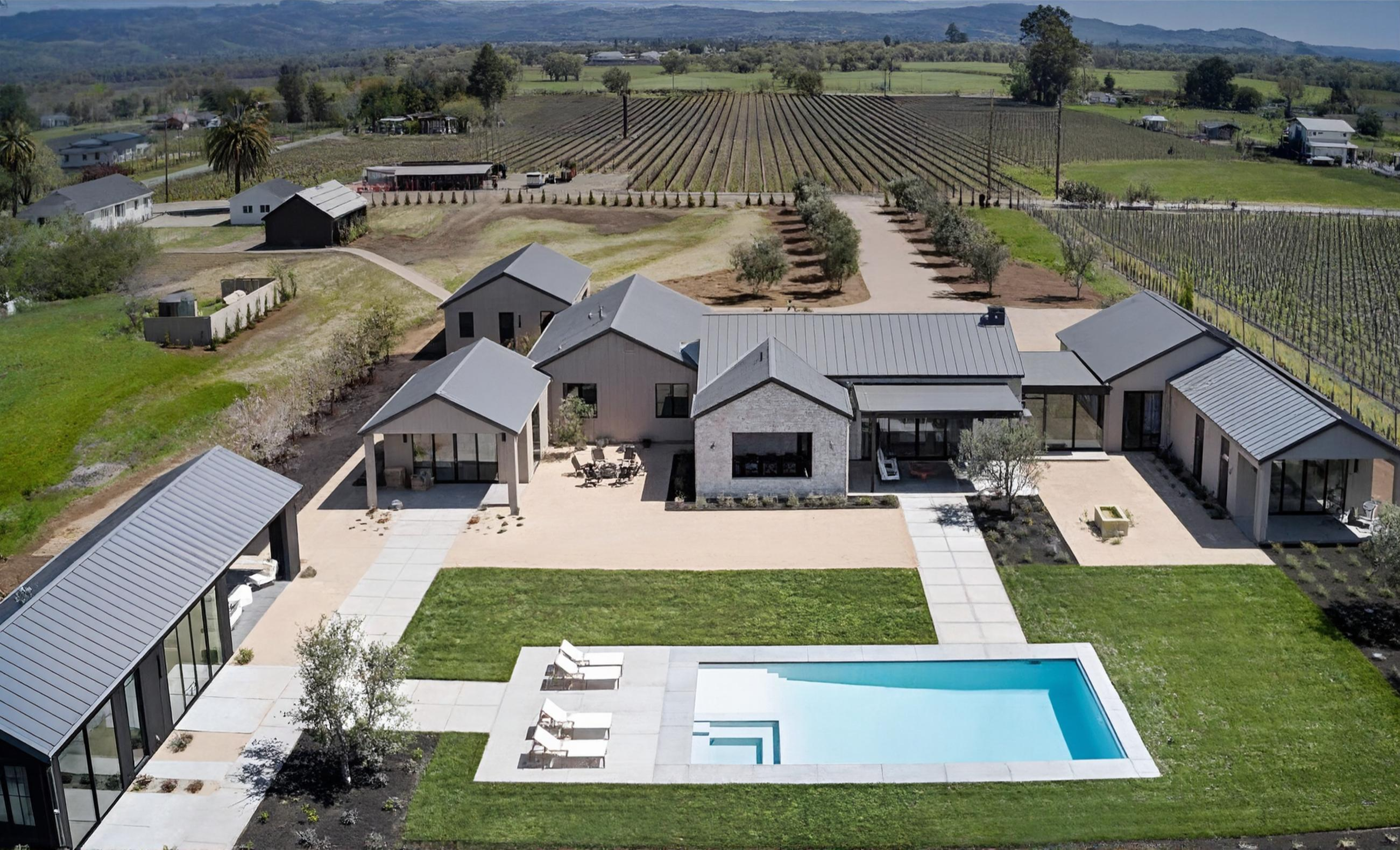 Aerial view of luxury estate with pool and vineyard