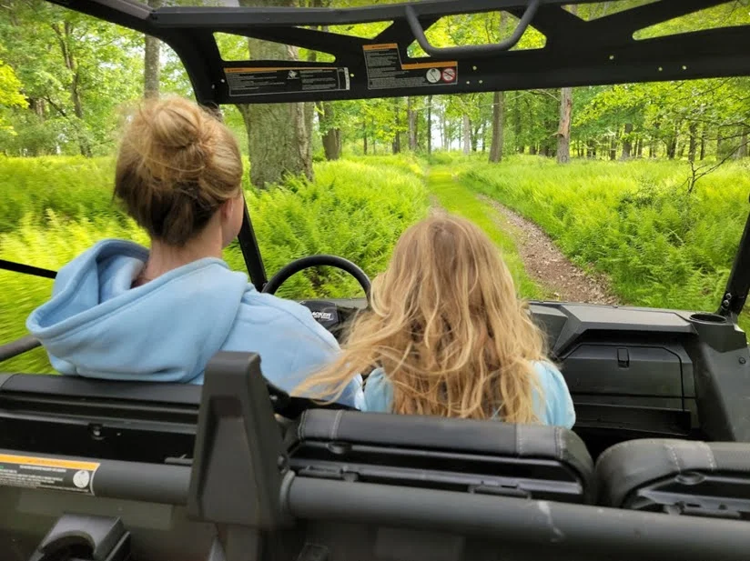 Girls enjoying an ATV ride through the trails