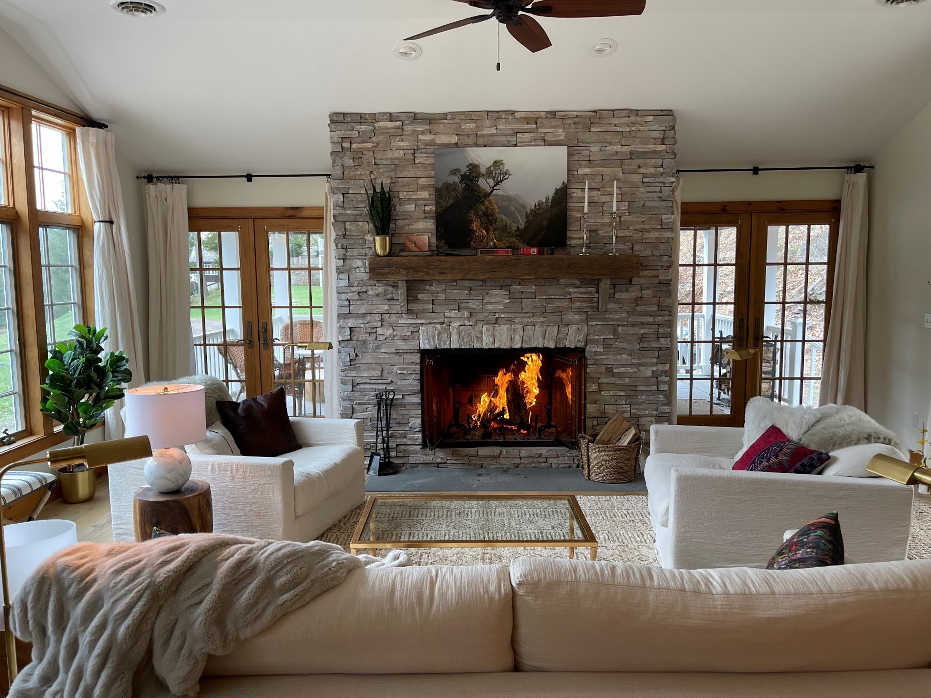 Cozy living room with stone fireplace at Graystones Preserve River Suites