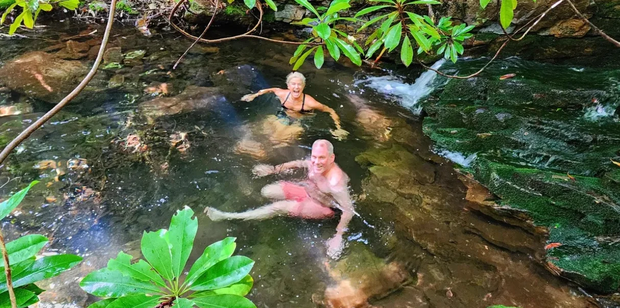 Couple enjoying the natural spring-fed cold plunge at Graystones Preserve