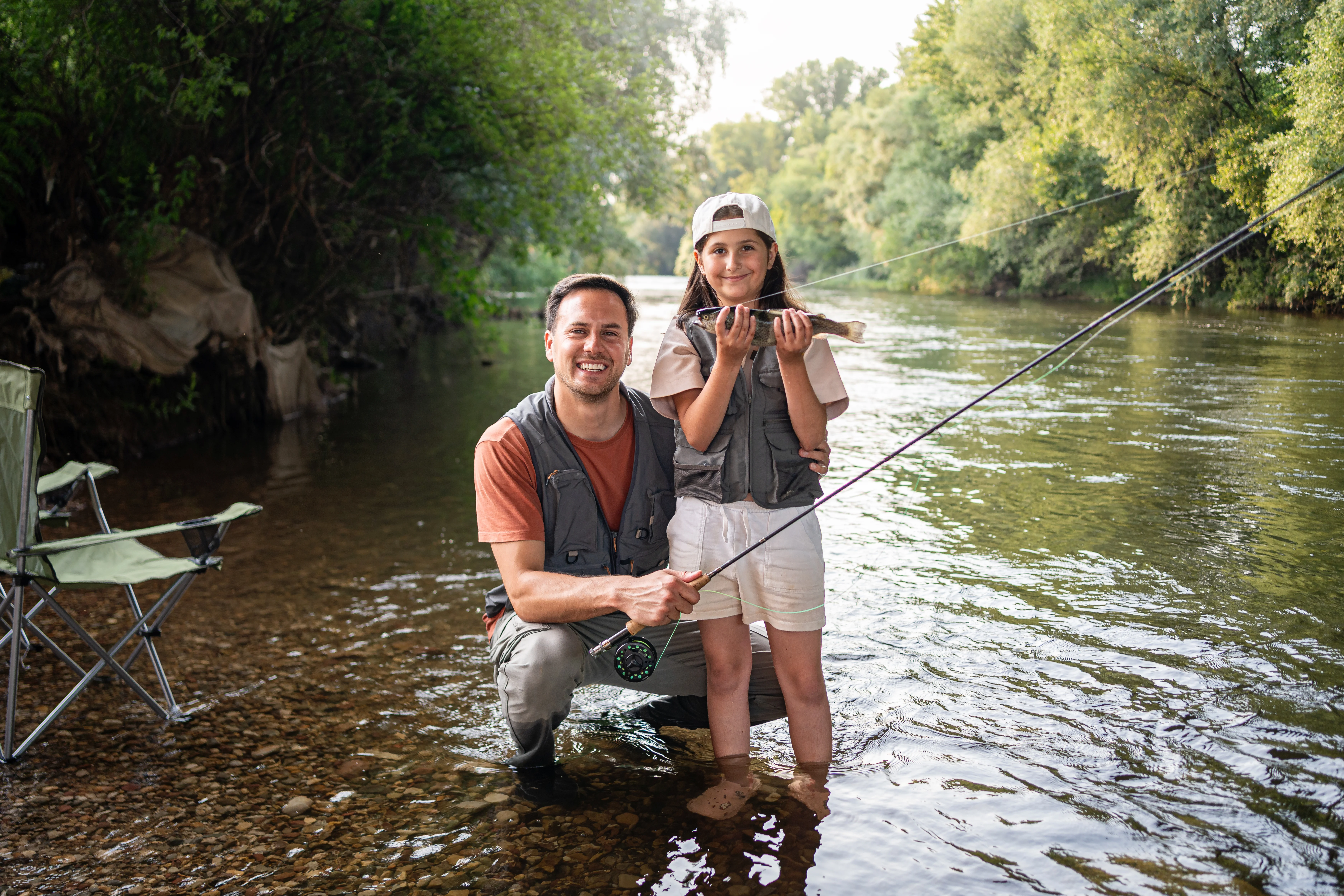 Father and daughter trout fishing together
