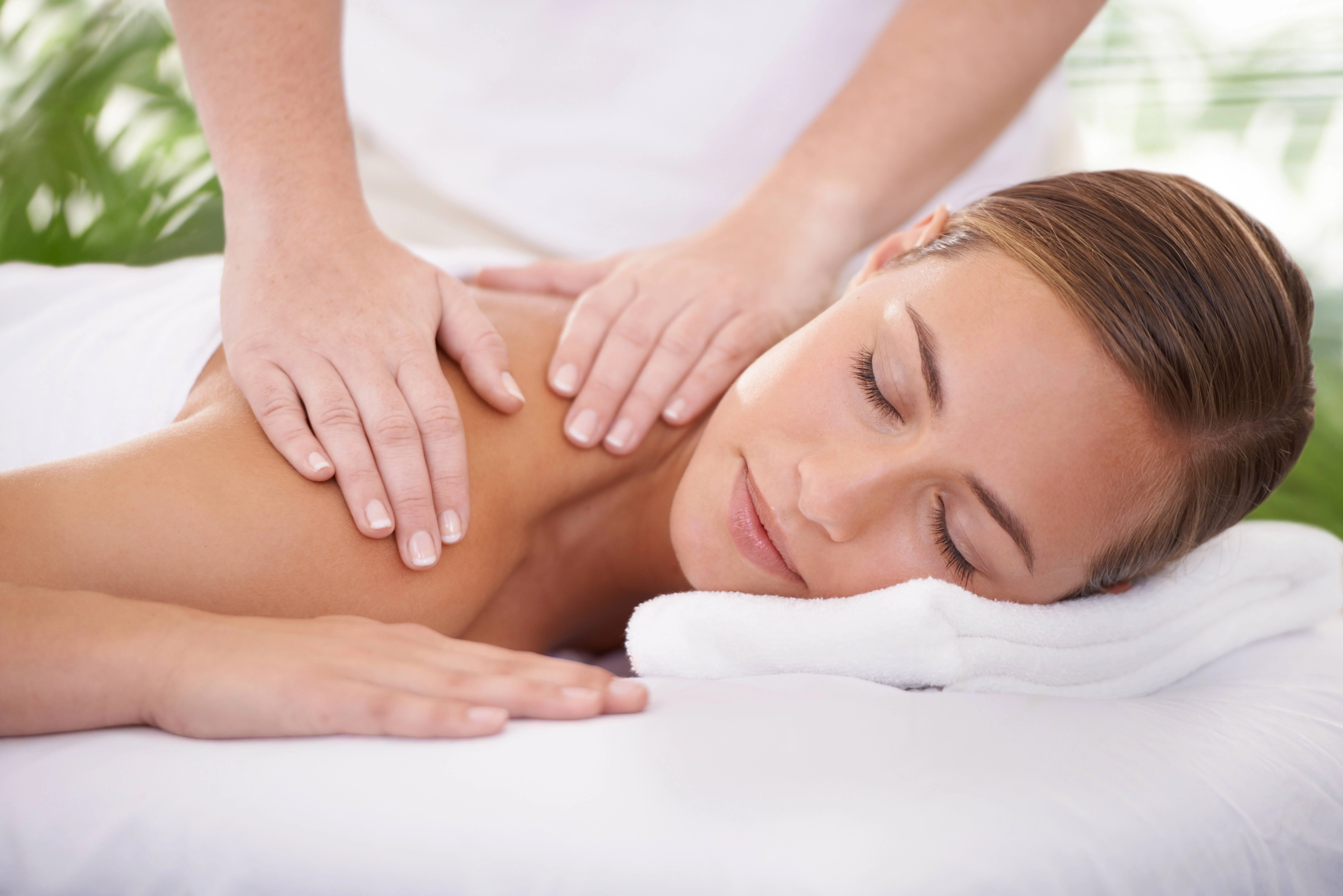 Guest receiving a relaxing massage in a serene outdoor setting